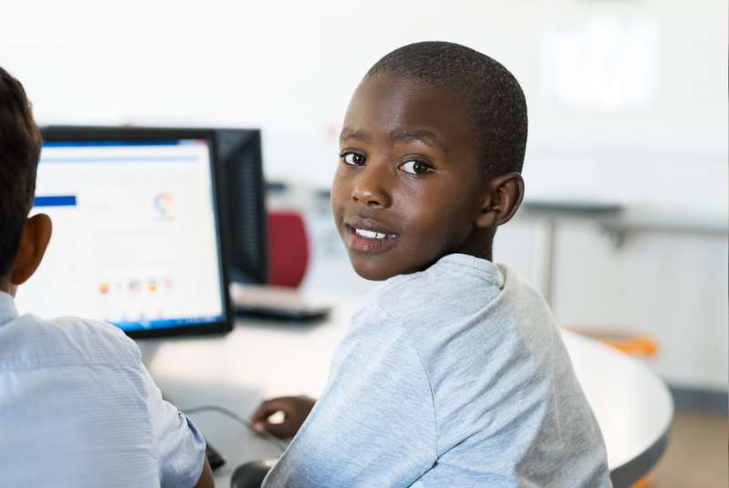 teenager sitting at a computer